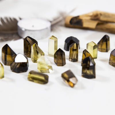 natural citrine points spread out on a taable
