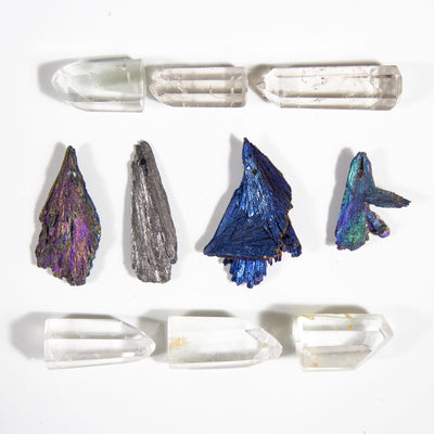 4 titanium treated kyanite blades with crystal points surrounding them
