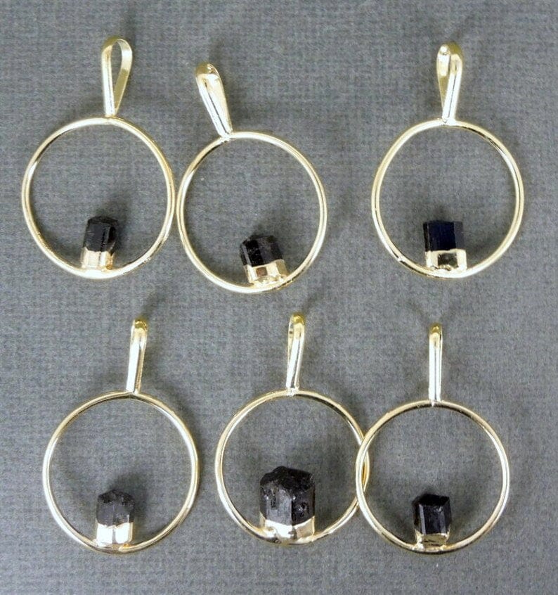 6 tourmaline pendants on gray background