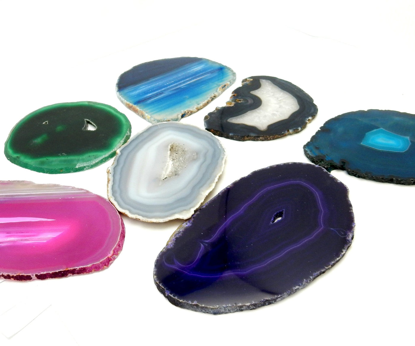 Picture of agate slices size 5 being displayed on a white back ground.