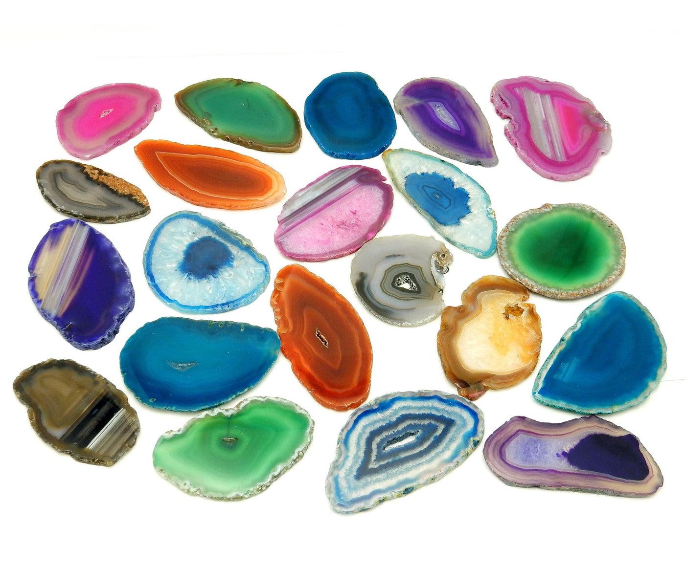 This Picture is showing the multiple colors we have available for our size 0 agate slices, also being displayed on a white background. 