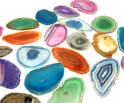 This Picture is showing the multiple colors we have available for our size 0 agate slices, also being displayed on a white background.