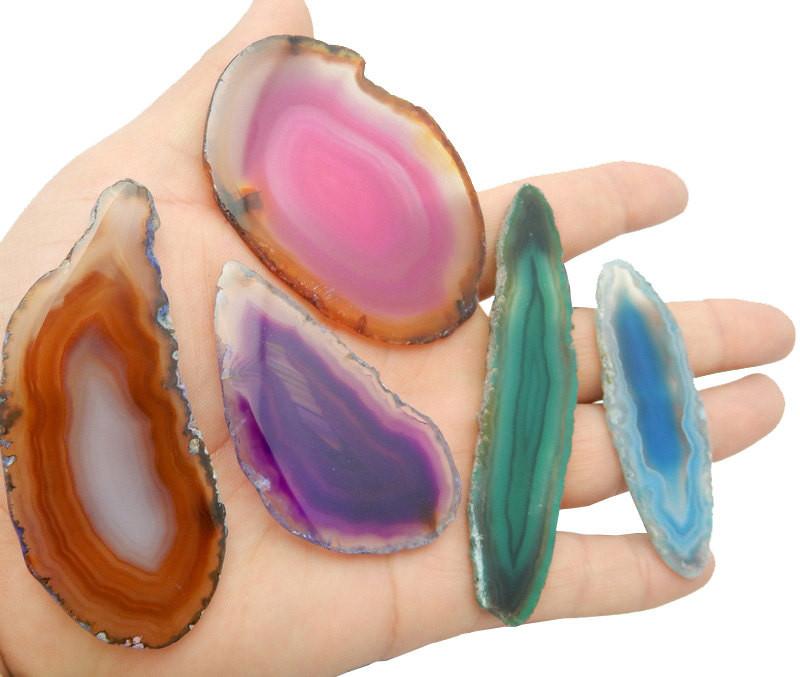 Picture of agate slices being displayed in hand for size reference.