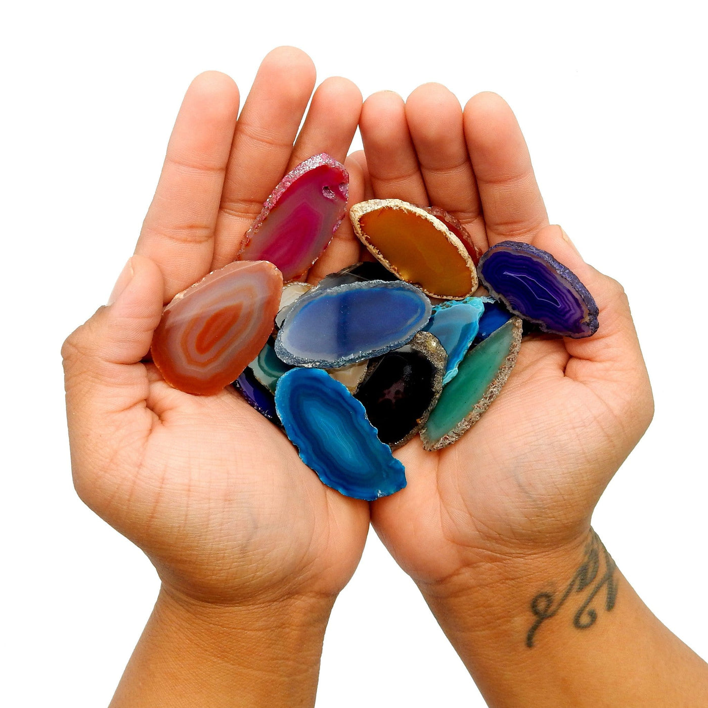 This picture is showing all the colors we have available for our size 000 agate slices, also they are also being displayed in hands. 