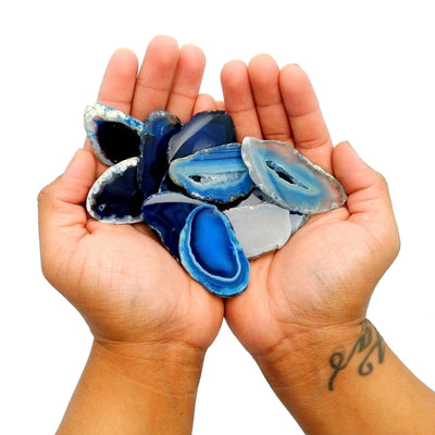 Picture of multiple blue agate slices in hand, for size reference.