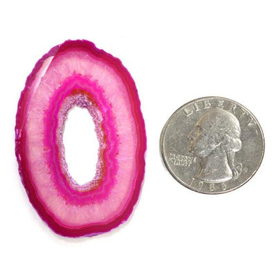 Picture of Pink extra grade agate next to quarter for size reference.