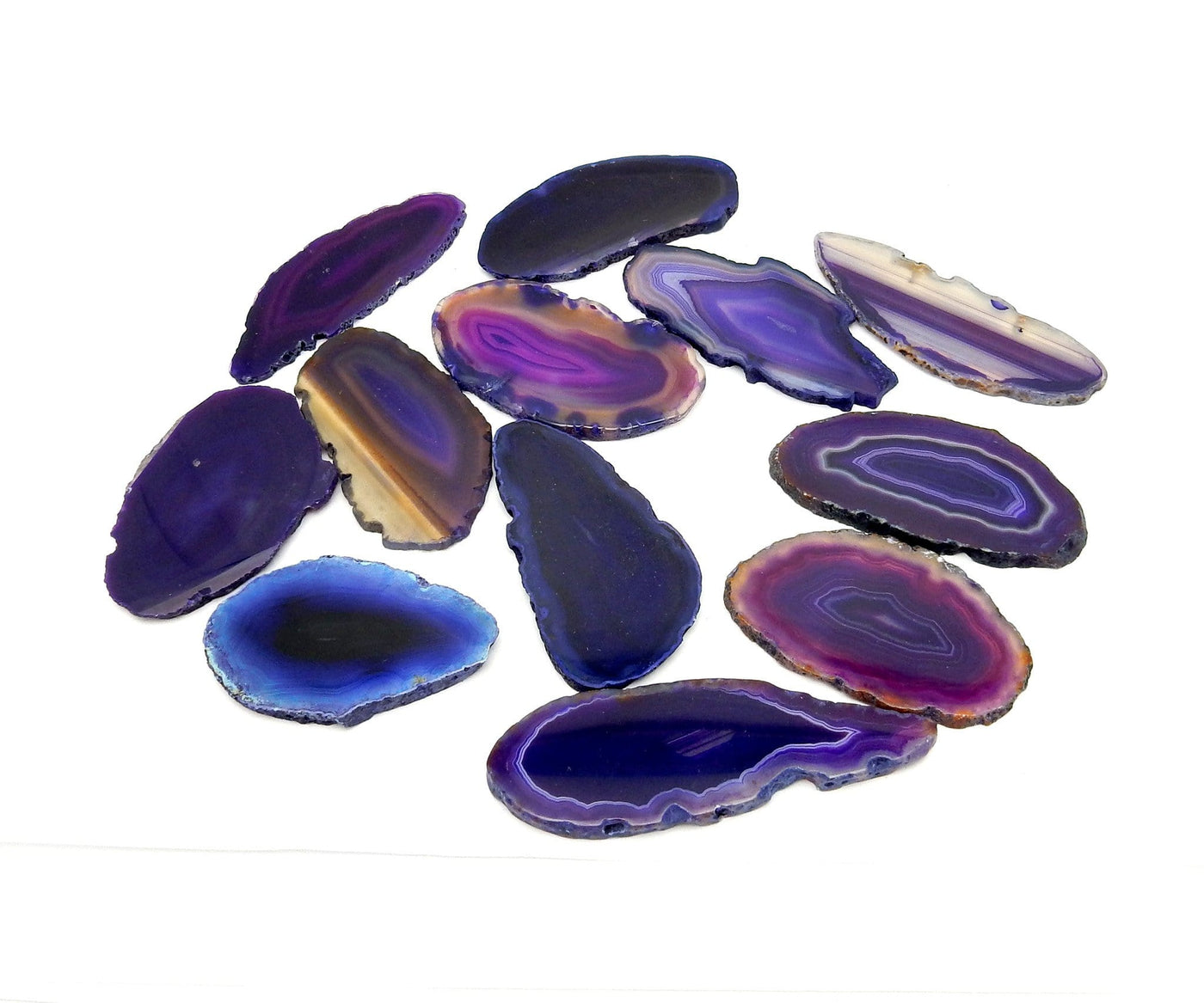 This picture is showing Purple agate slices being Displayed on a white back ground. 