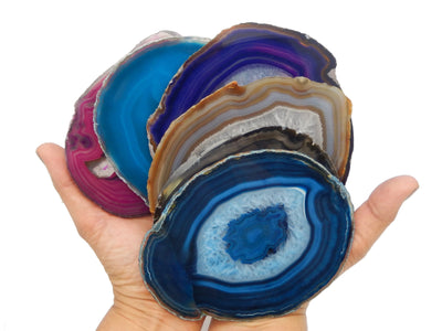 All variations for our agate slices size 6 are being displayed in hands for size reference, also in an all white background.  