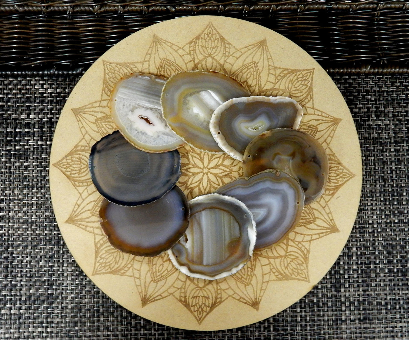 natural agate slices being displayed on a wooden grid.