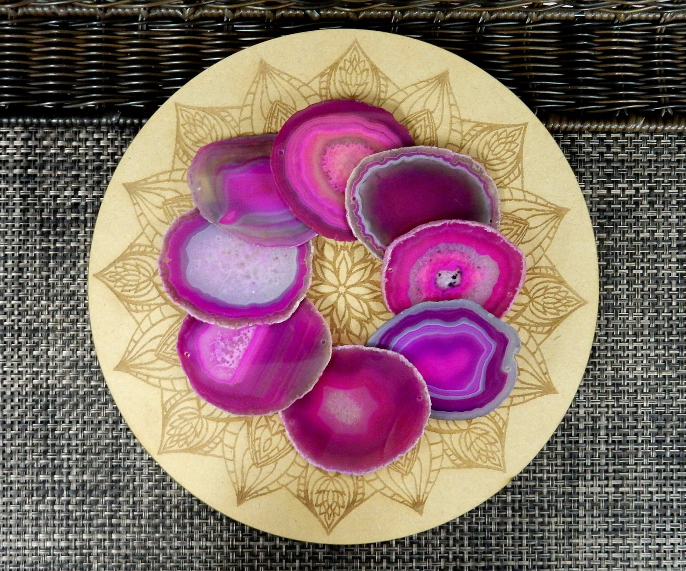 Picture of multiple pink agate slices, being displayed on a wooden grid