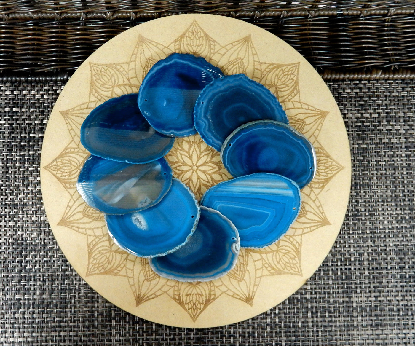 blue agate slices being displayed on a wooden grid.