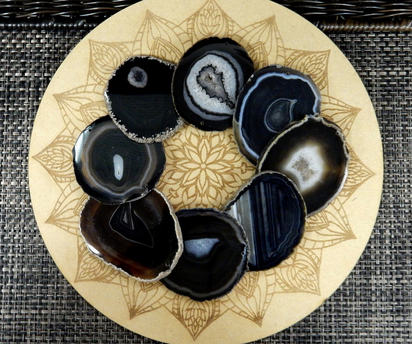 Black agate slices being displayed on a wooden grid.