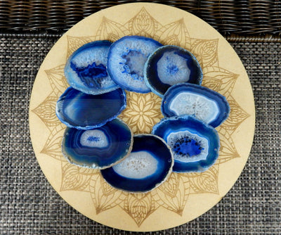 Blue agate slices size 2 being displayed on a wooden grid. 
