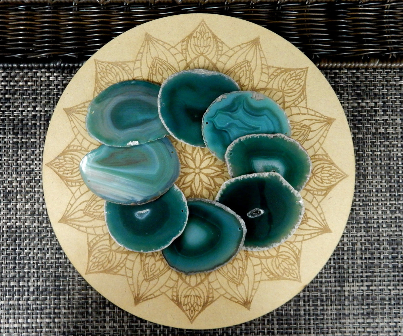 green agate slices being displayed on a wooden grid.