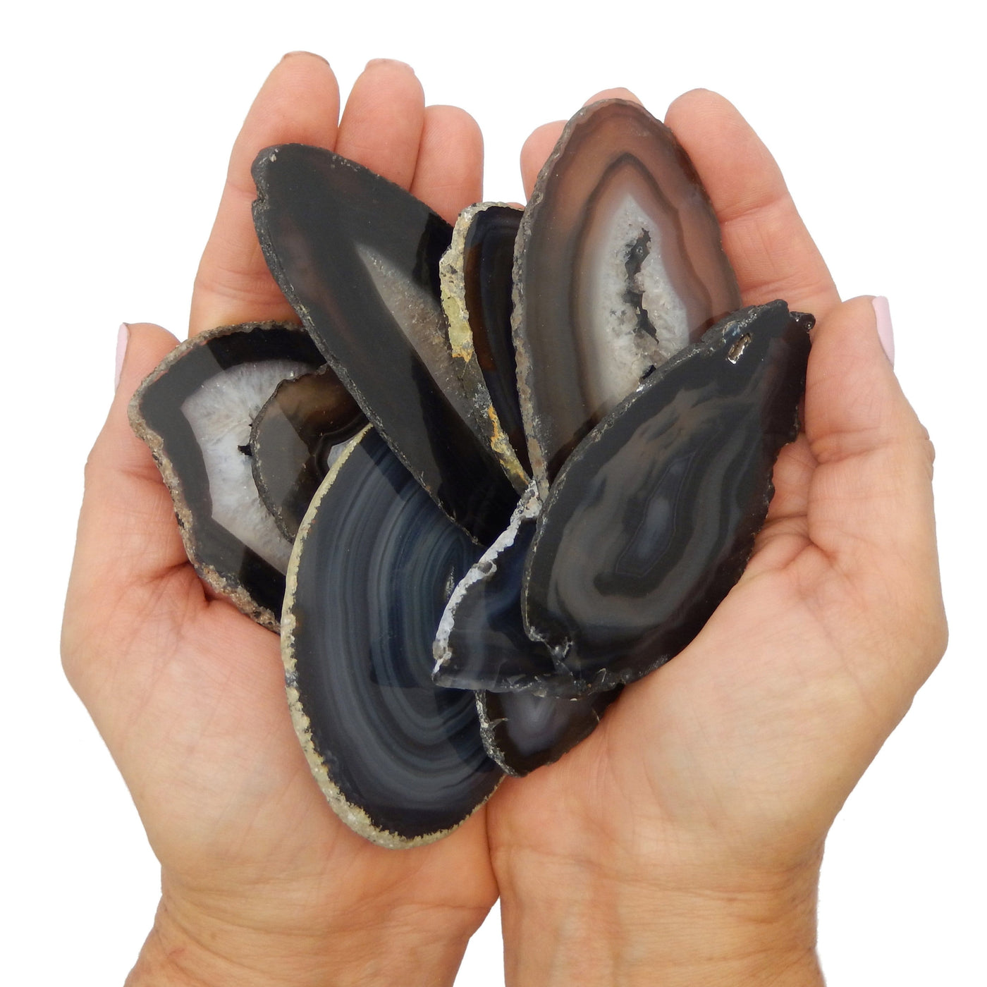 Two Hands holding up the variety of Black Agate Slice Coaster
