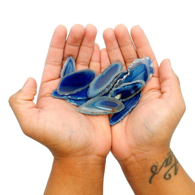 blue agate slices in two hands