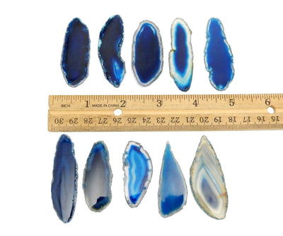 10 blue agate slices next to a ruler