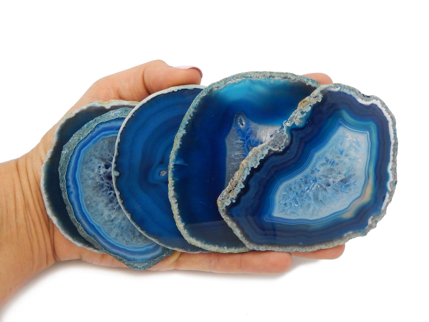 blue agate slice size 3 displayed in hand for size reference and shape reference