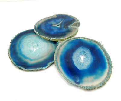 blue agate slices displayed on white background to show various blue tones and natural formations