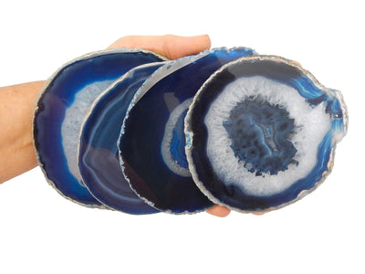large blue agate slices in a hand