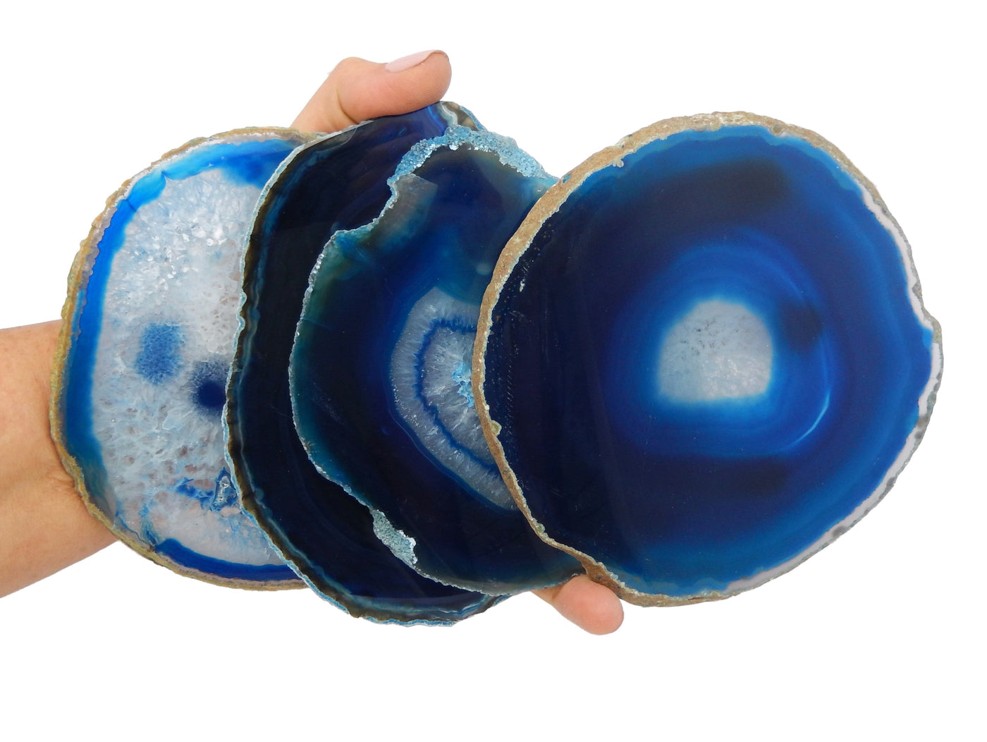 Blue agate slice size number 6 in hand for size and characteristic reference