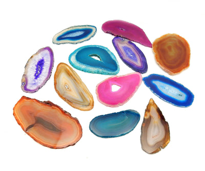 Twelve differently colored Agate Slices displayed on a white surface.