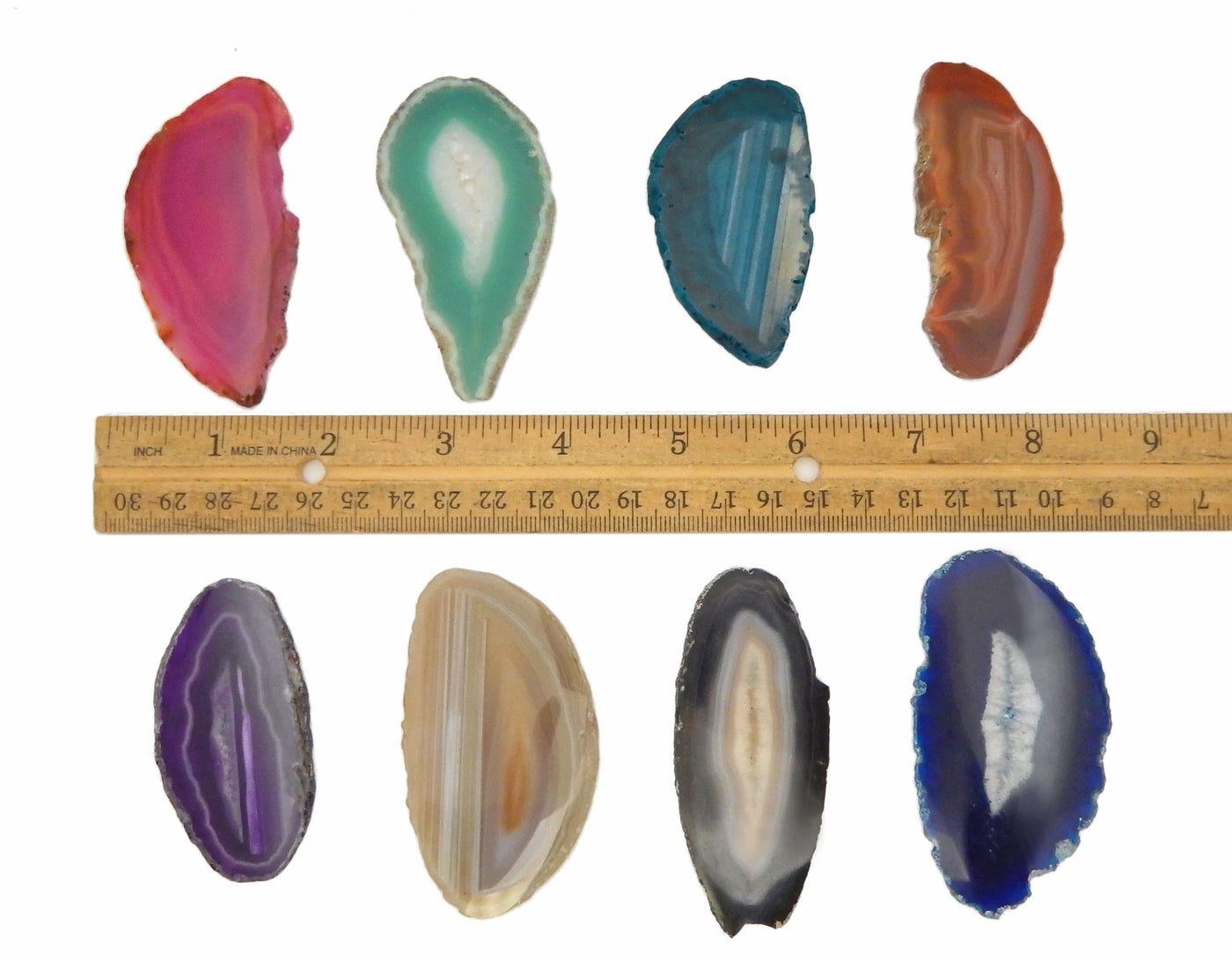 Assorted Color Agate Slices Drilled on White Background.  