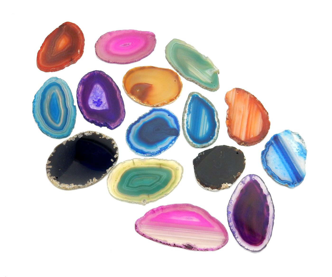 Assorted Drilled Agate Slices By Color on White Background.