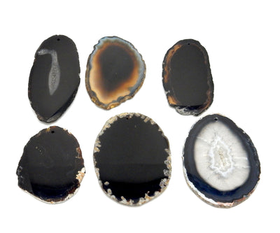 6 Black Agate Slices Drilled on White Background.