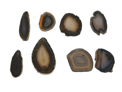 8 Black Agate Slices Drilled on White Background.