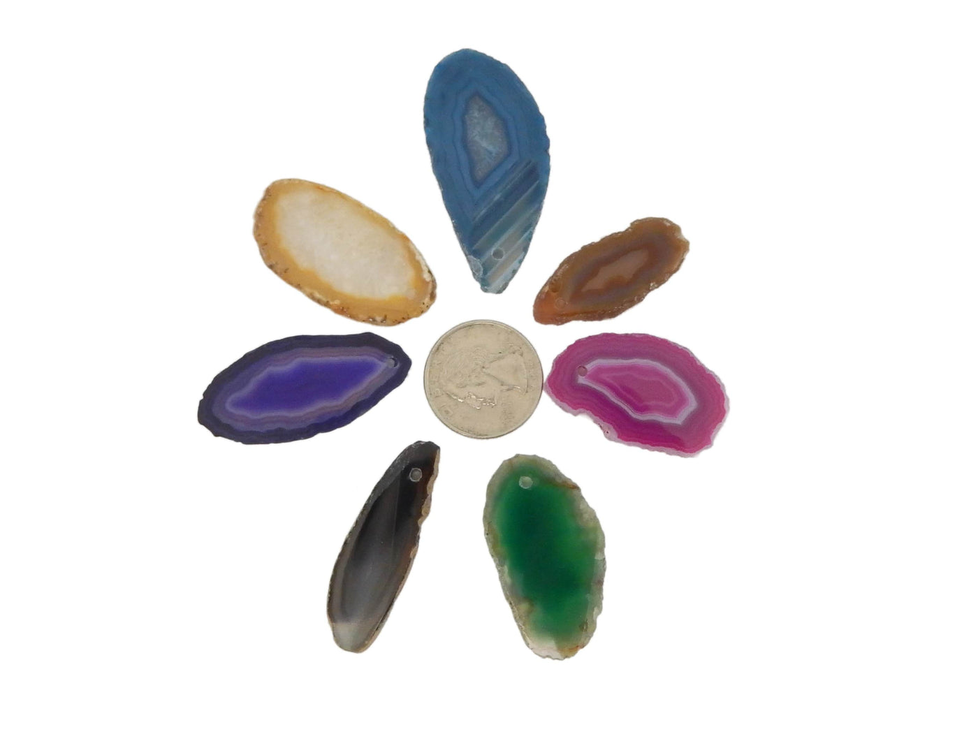 7 Different Color Agate Slices Drilled Around a Quarter on White Background.