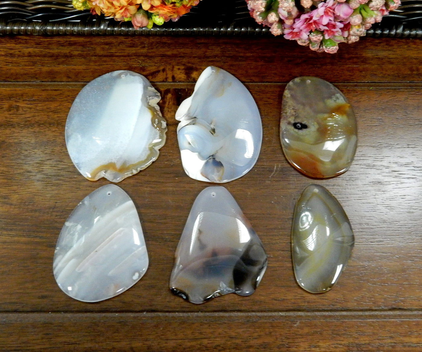 6 Natural FreeForm Agate Slices with Polished Edge on Wooden Background.