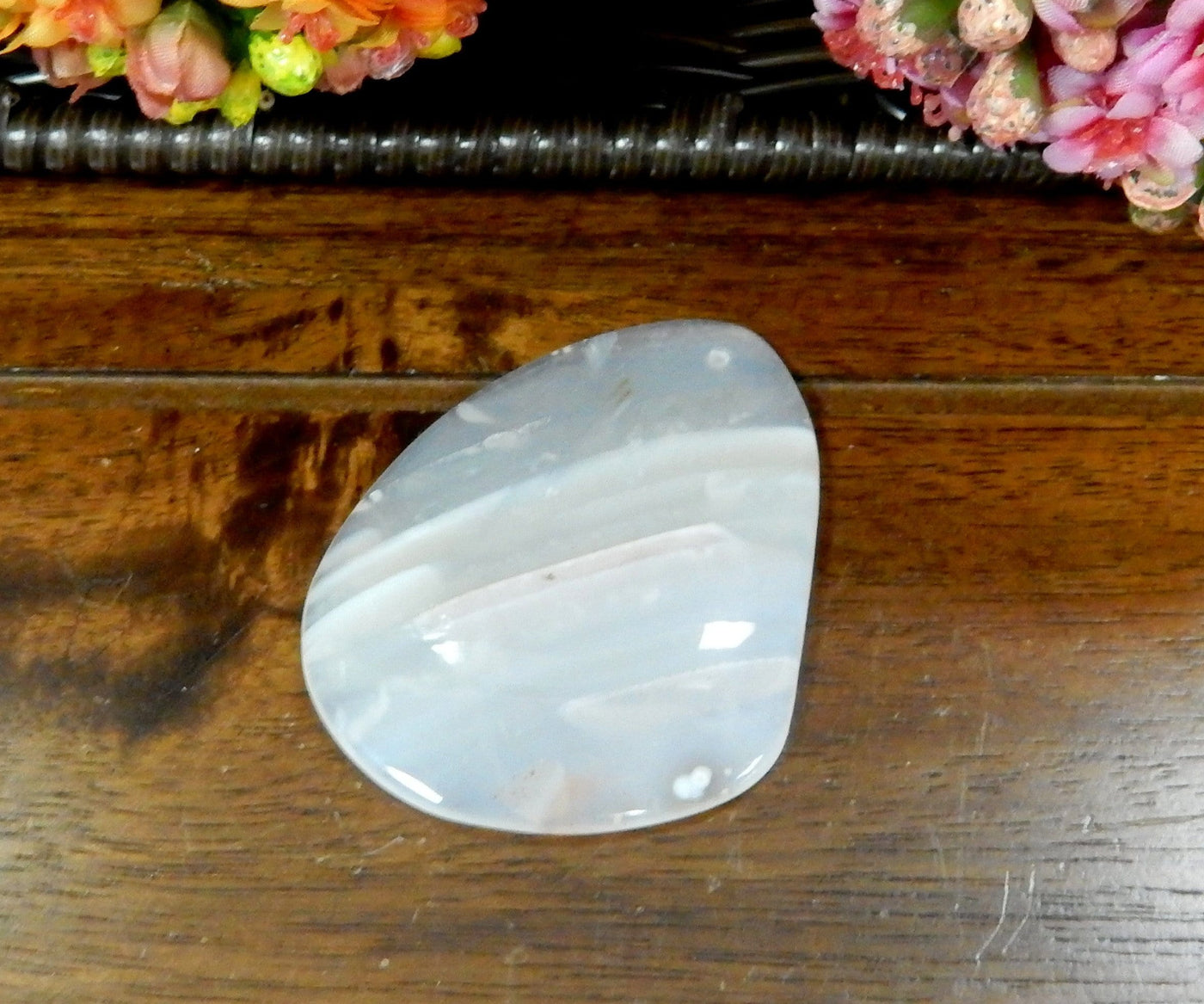 Natural Drilled Freeform Agate Slices With Polished Edge on Wooden Background.
