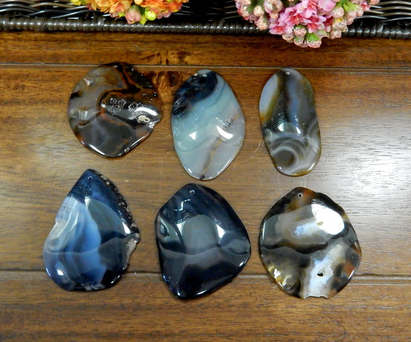 6 Black FreeForm Agate Slices with Polished Edge on Wooden Background.