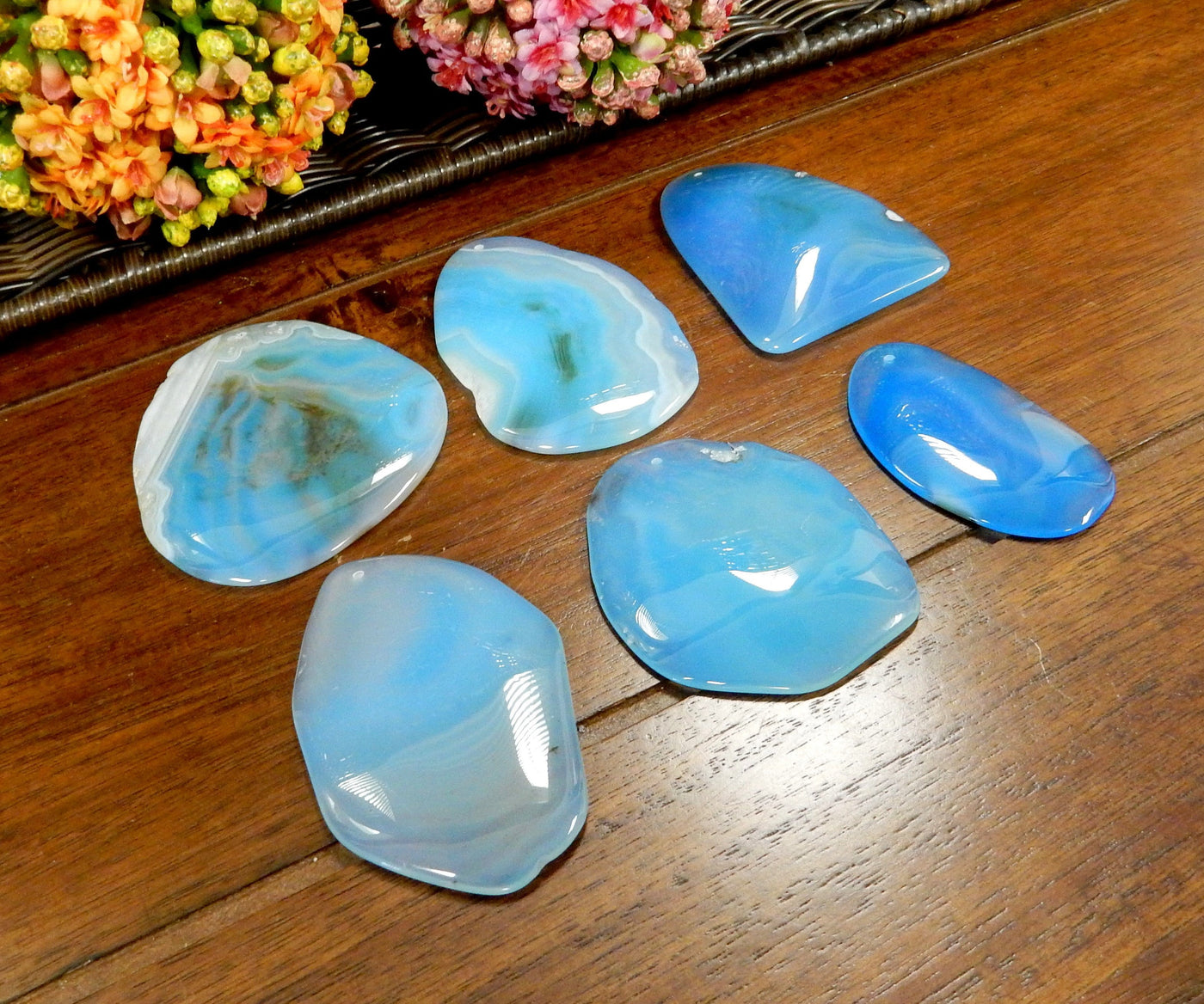 Side Angle 6 Light Blue FreeForm Agate Slices with Polished Edge on Wooden Background.
