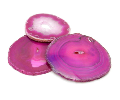 3 pink agate slices on a white background showing each pattern is unique.