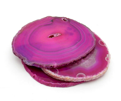 a stack of 3 pink agate slices on a white background.