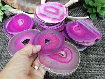 pink agate slices in a hand