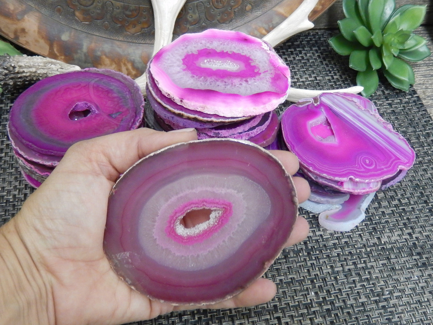 pink agate slice in a hand