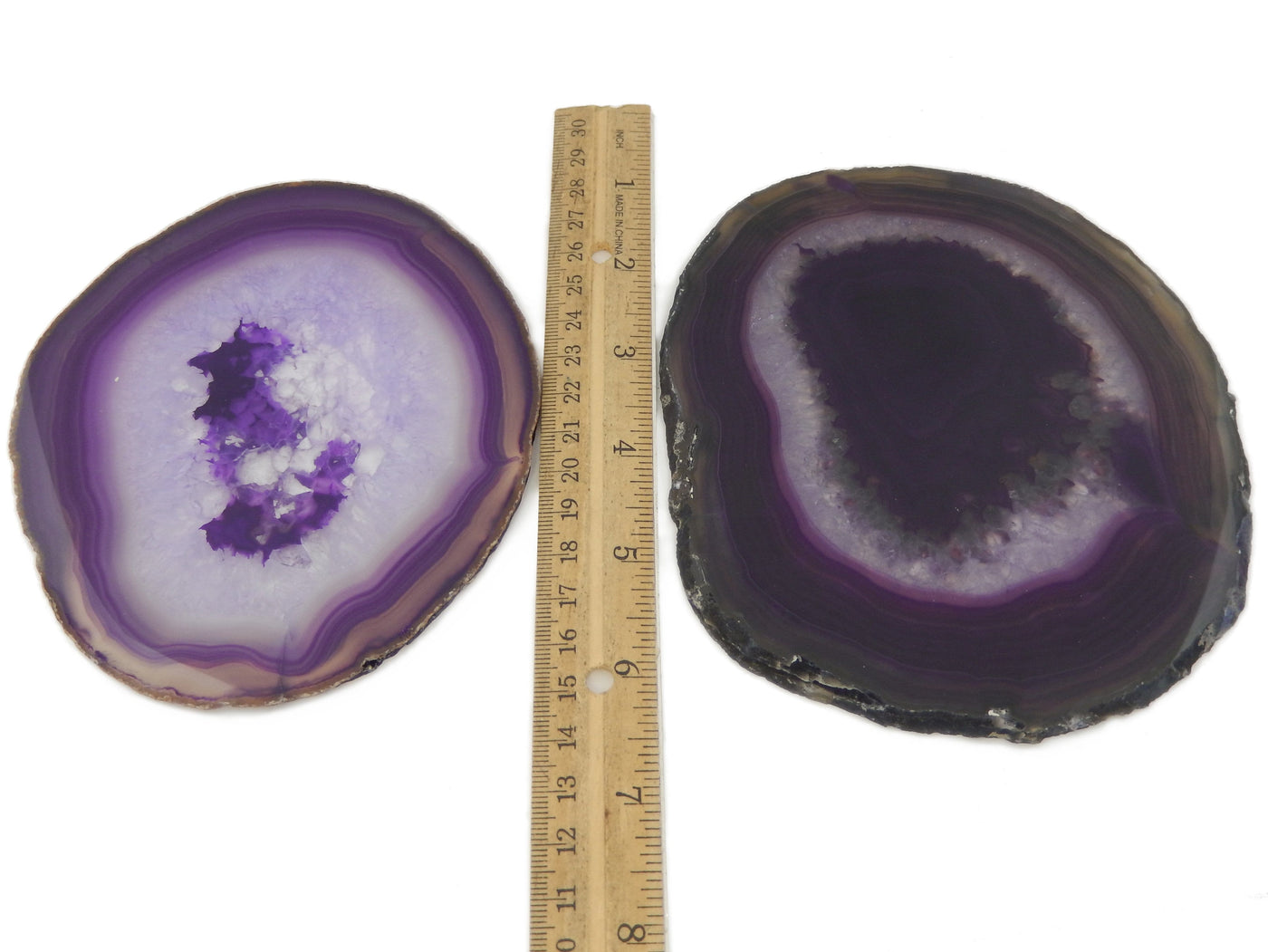 2 purple agate slices next to a ruler