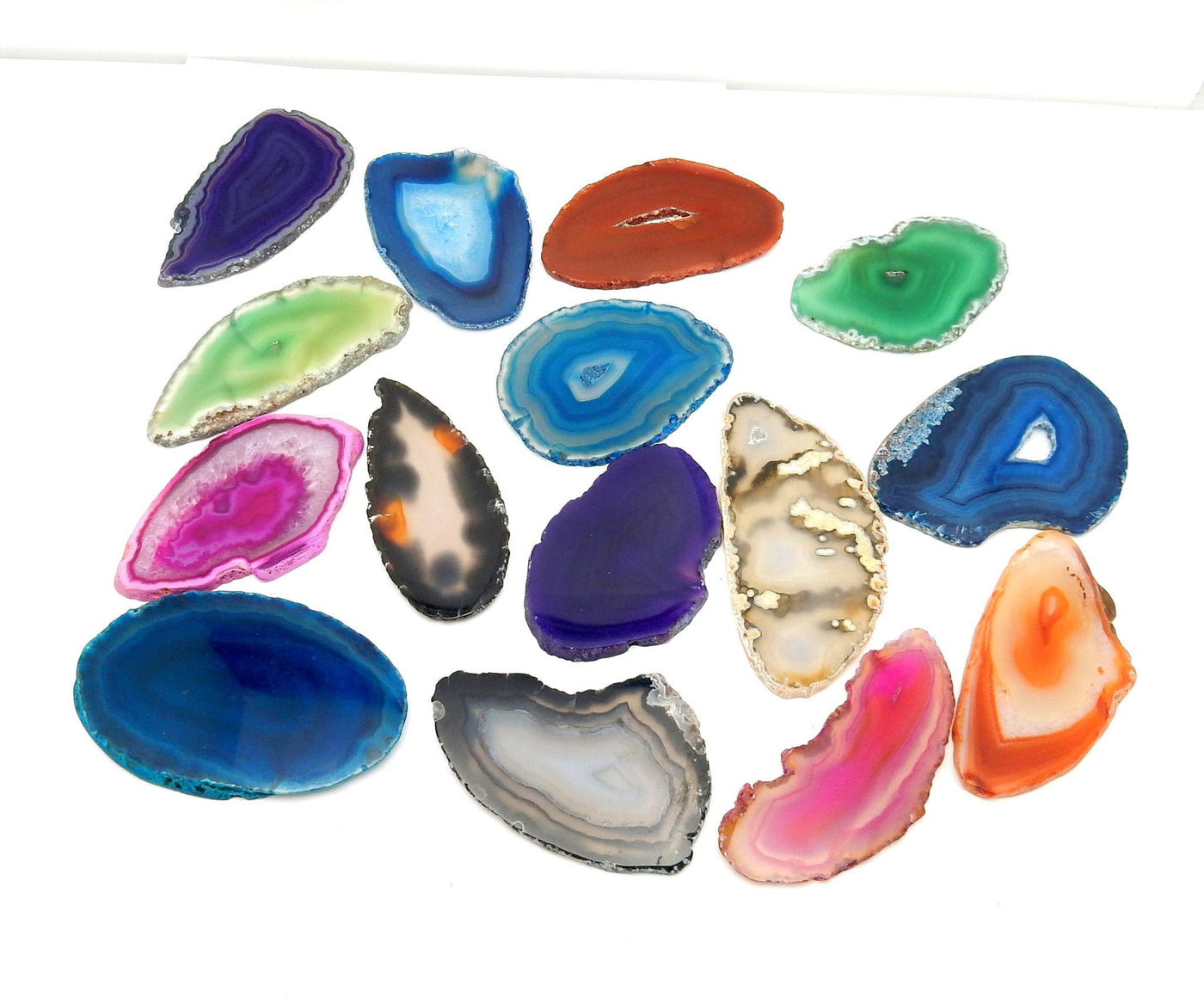 Assorted colors of agate slices available in the shop on a white background.