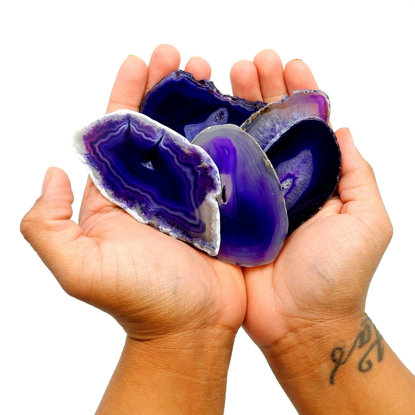 purple agate slices in a hand