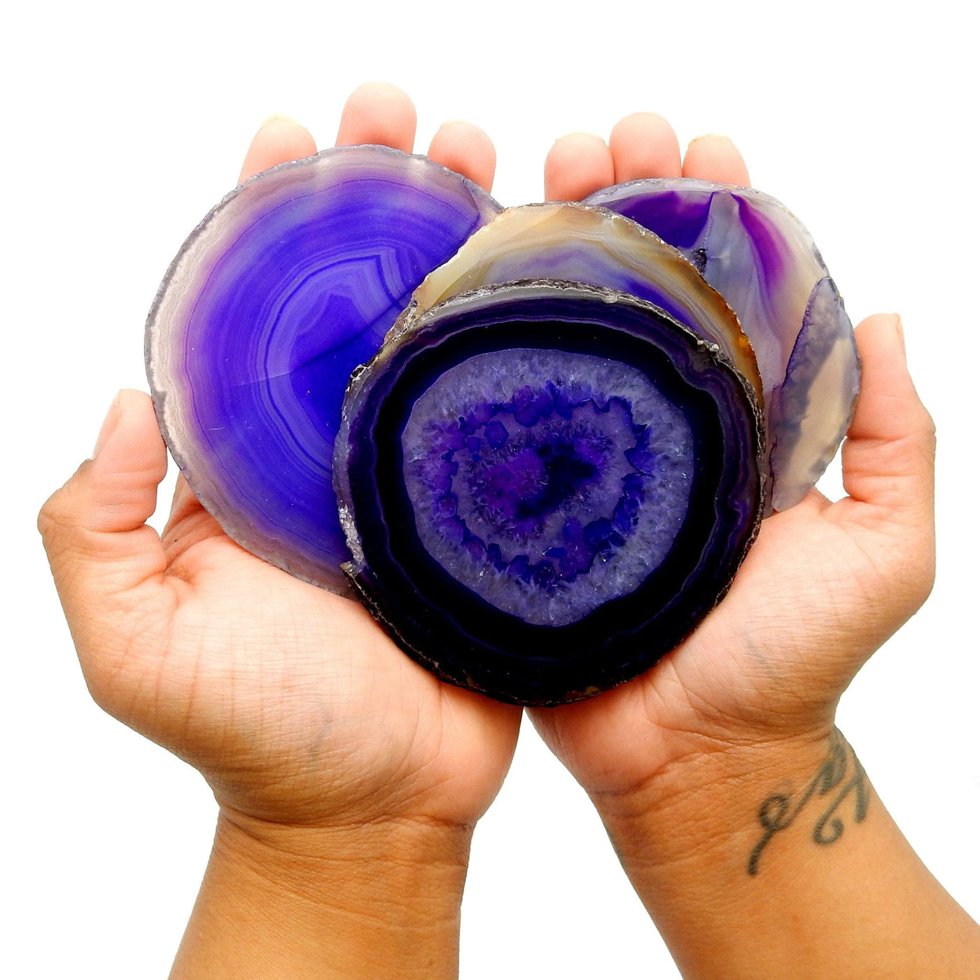 large purple agate slices in 2 hands