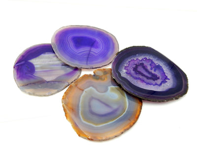 4 purple agate slices on a table