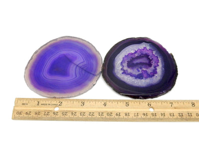 2 agate slices next to a ruler