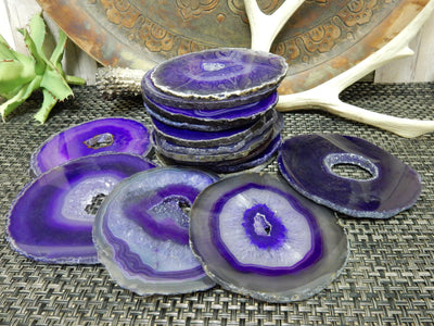 Purple agates piled to show thickness while 5 are on mat to show difference in Druzy opening 