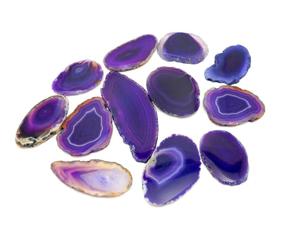 Purple Agate Slices - Size 000 spread out on a table to show different colors and shapes