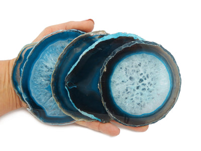 Hand holding 5 Teal Agate Slice in a size number Four