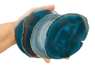 Hand holding 4 Teal Agate Slice in a size number Five