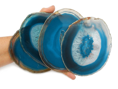 Hand holding 4 Teal Agate Slice in a size number 6